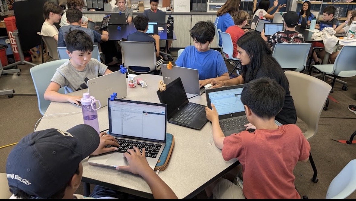 Khushi helping students code during FLL camp
