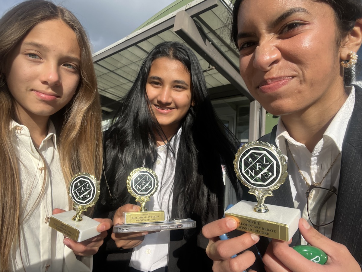 Khushi with Speech and Debate trophies